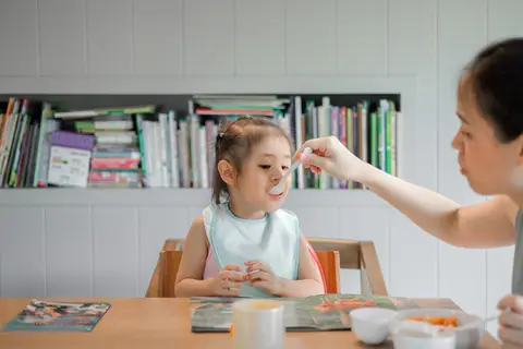 Lương bảo mẫu TP.HCM — bảo mẫu đút bé ăn tại bàn ăn gia đình